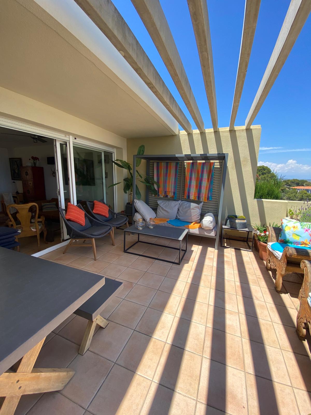 the terrace with shade, seats and table
