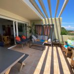 the terrace with shade, seats and table