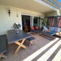 seats and table on the terrace, with shade