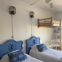 three persons bedroom with two beds and an additional one for a kid