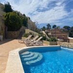 the swimming-pool, flowers, sun loungers and beach towels