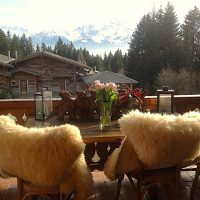 Very comfortable terrace with wood seats and a breathtaking view over the mountains